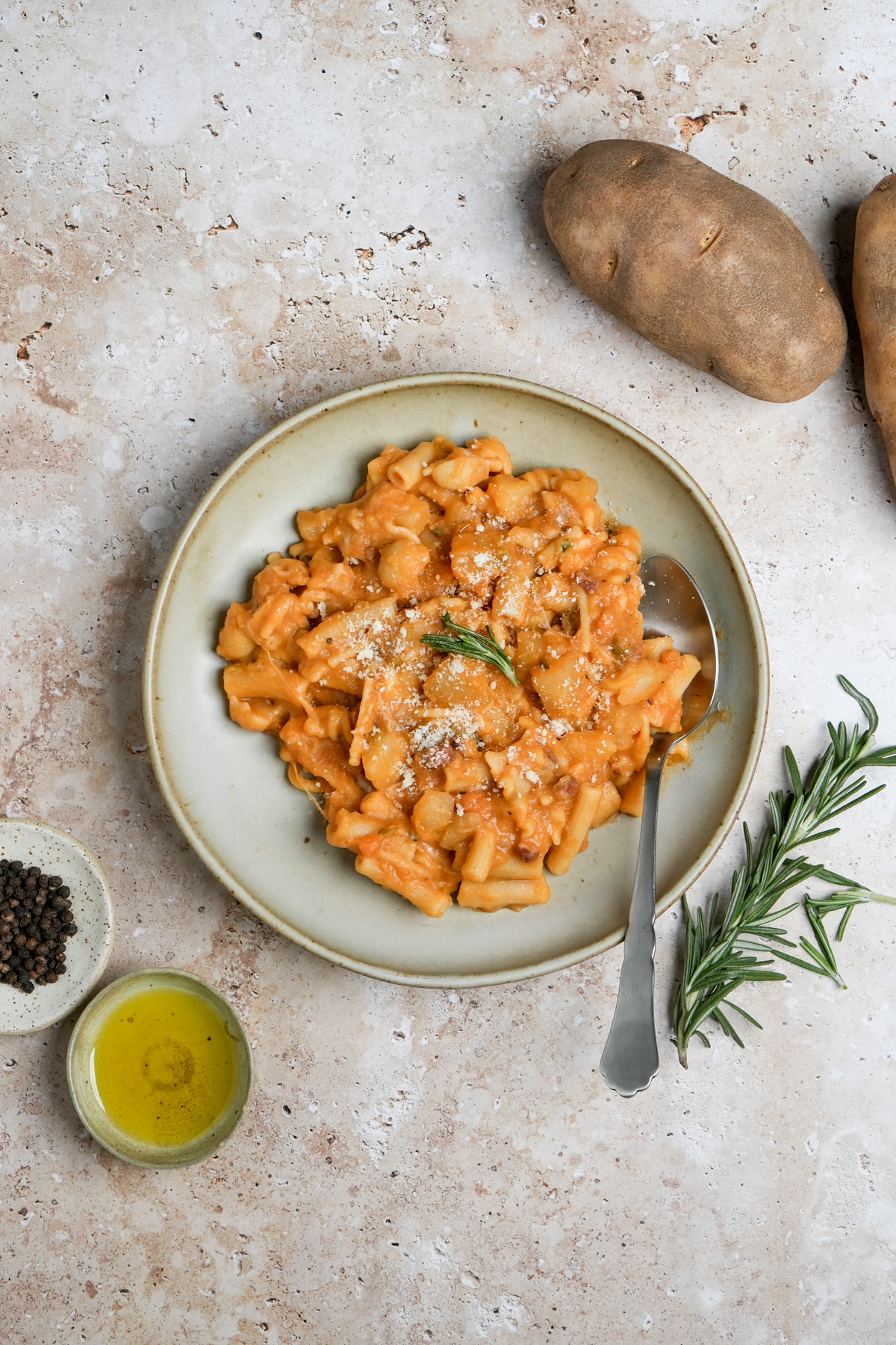 Italian pasta with potatoes in a bowl with a spoon