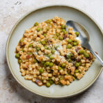 Italian pea and pasta soup in a bowl with a spoon