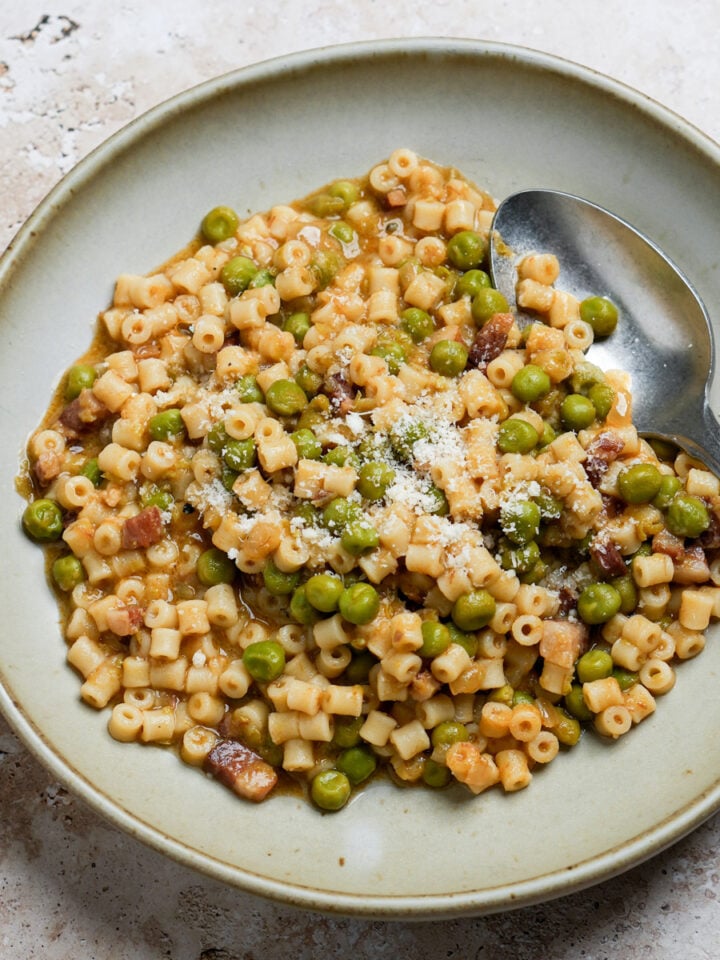 Italian pea and pasta soup in a bowl with a spoon