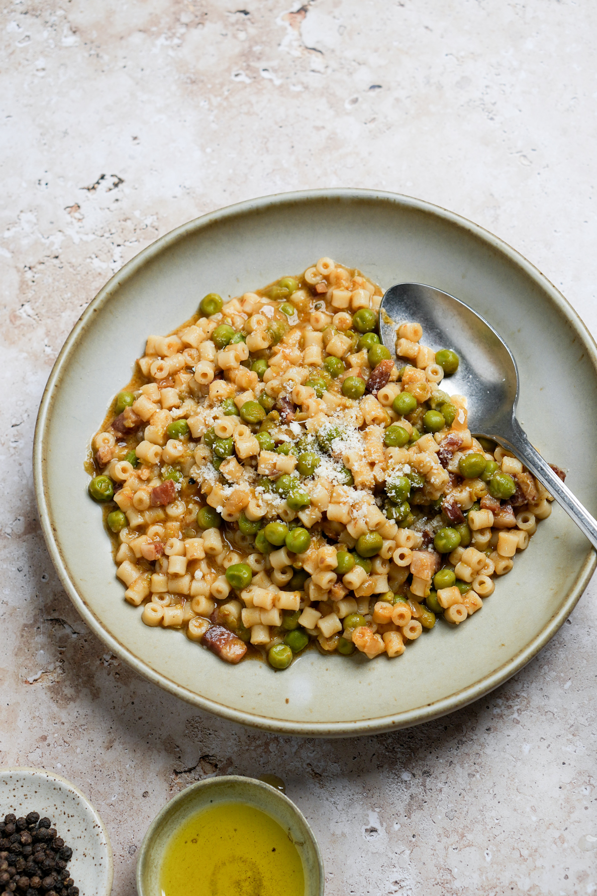 Plate of pasta e piselli with a spoon in it