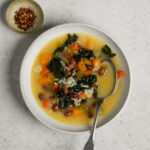 bowl of vegetarian soup with rice with a spoon