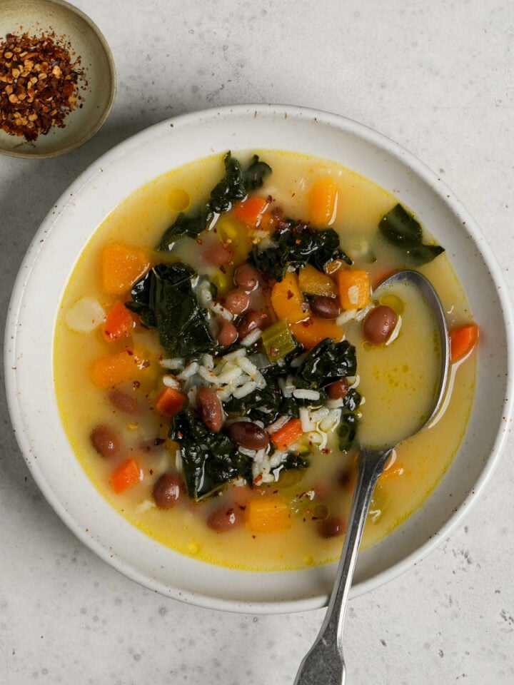 bowl of vegetarian soup with rice with a spoon