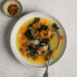 Vegetarian soup with rice in a bowl with a spoon