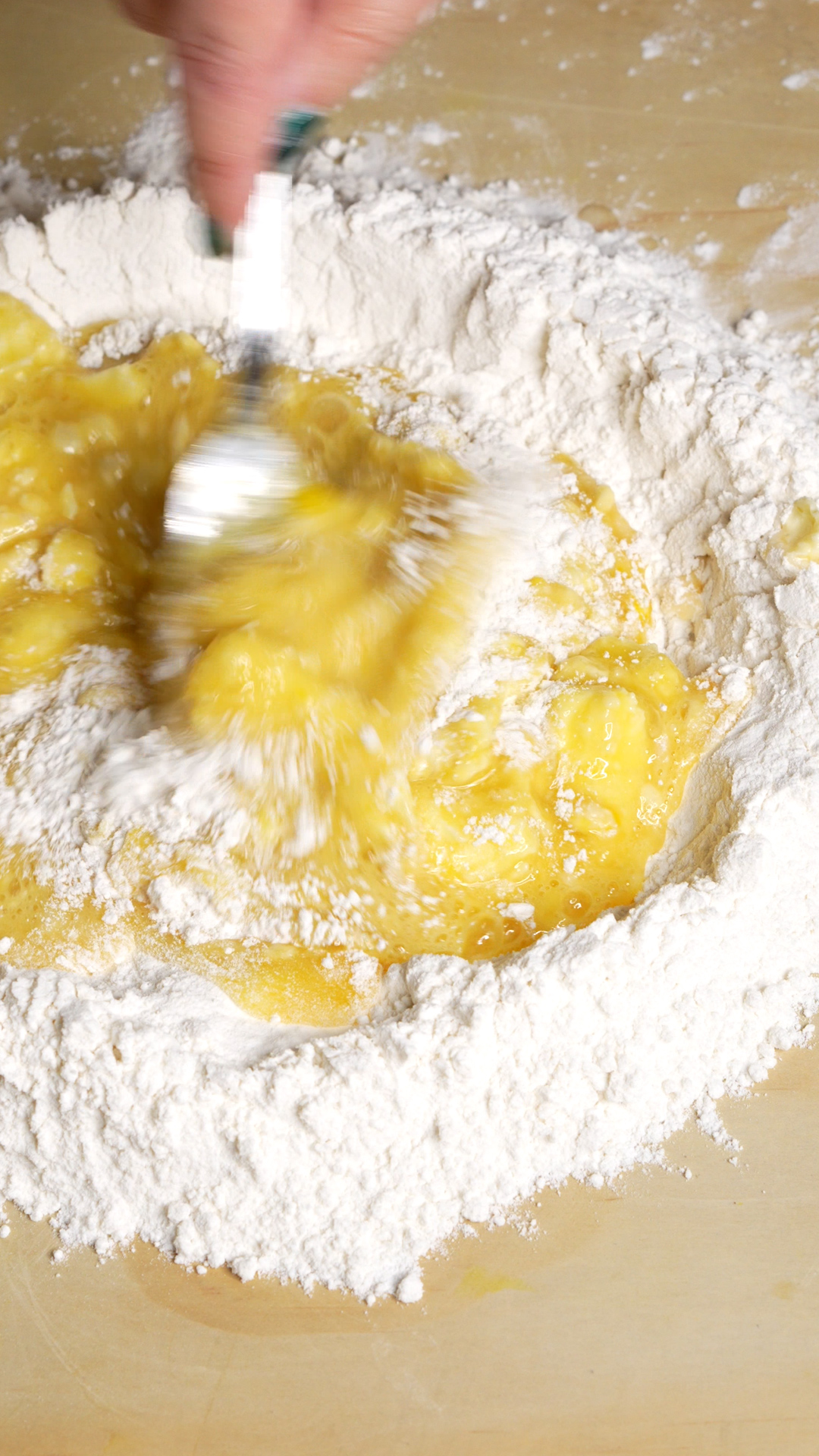 Whisking egg mixture in well with a fork