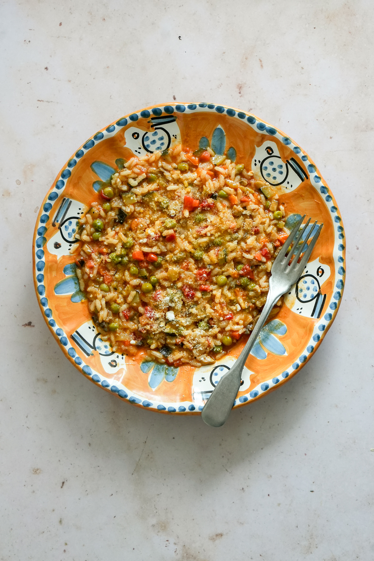 Vegetable risotto in a plate with a fork