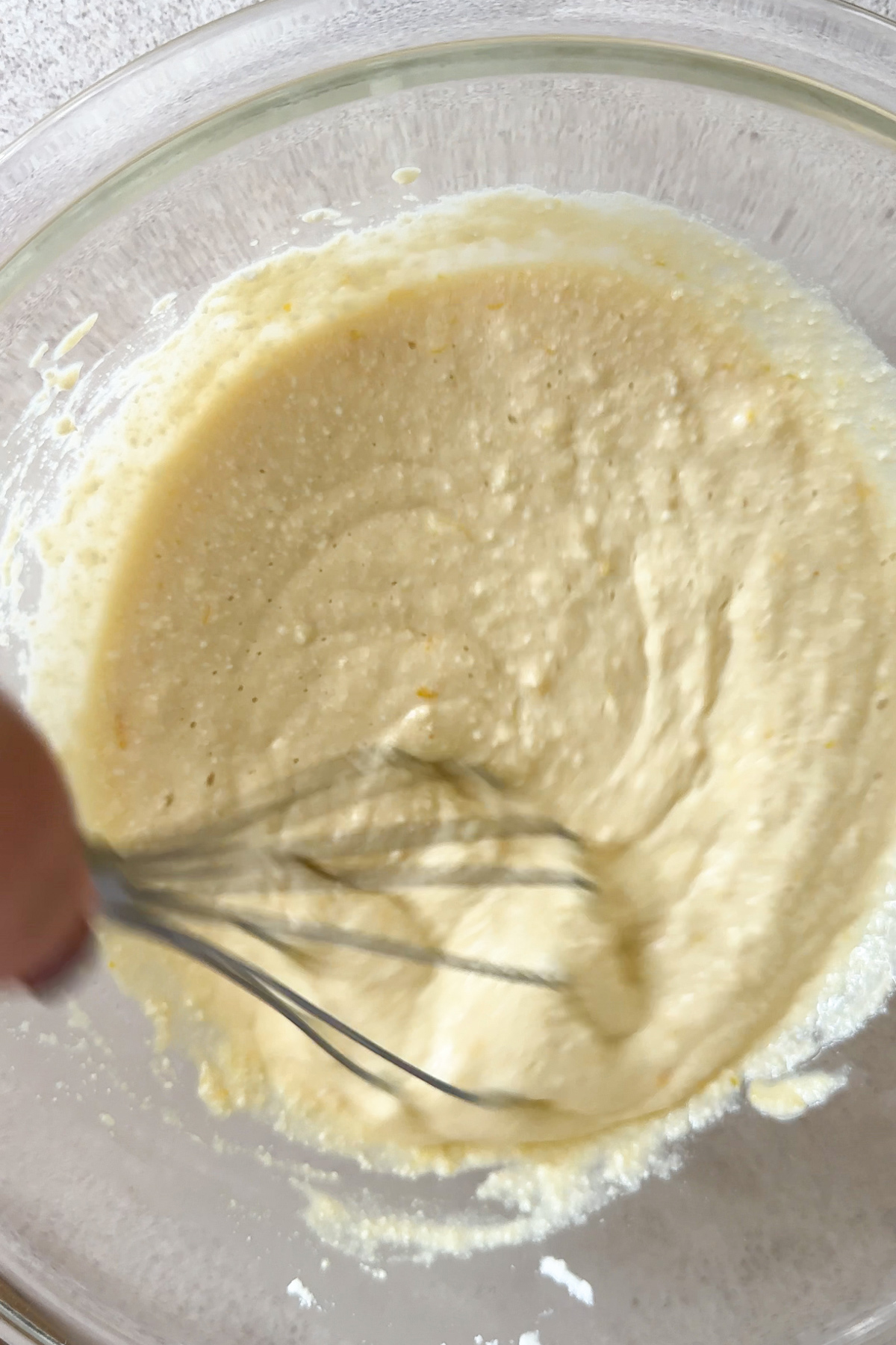 wet ingredients being mixed in a bowl with a whisk