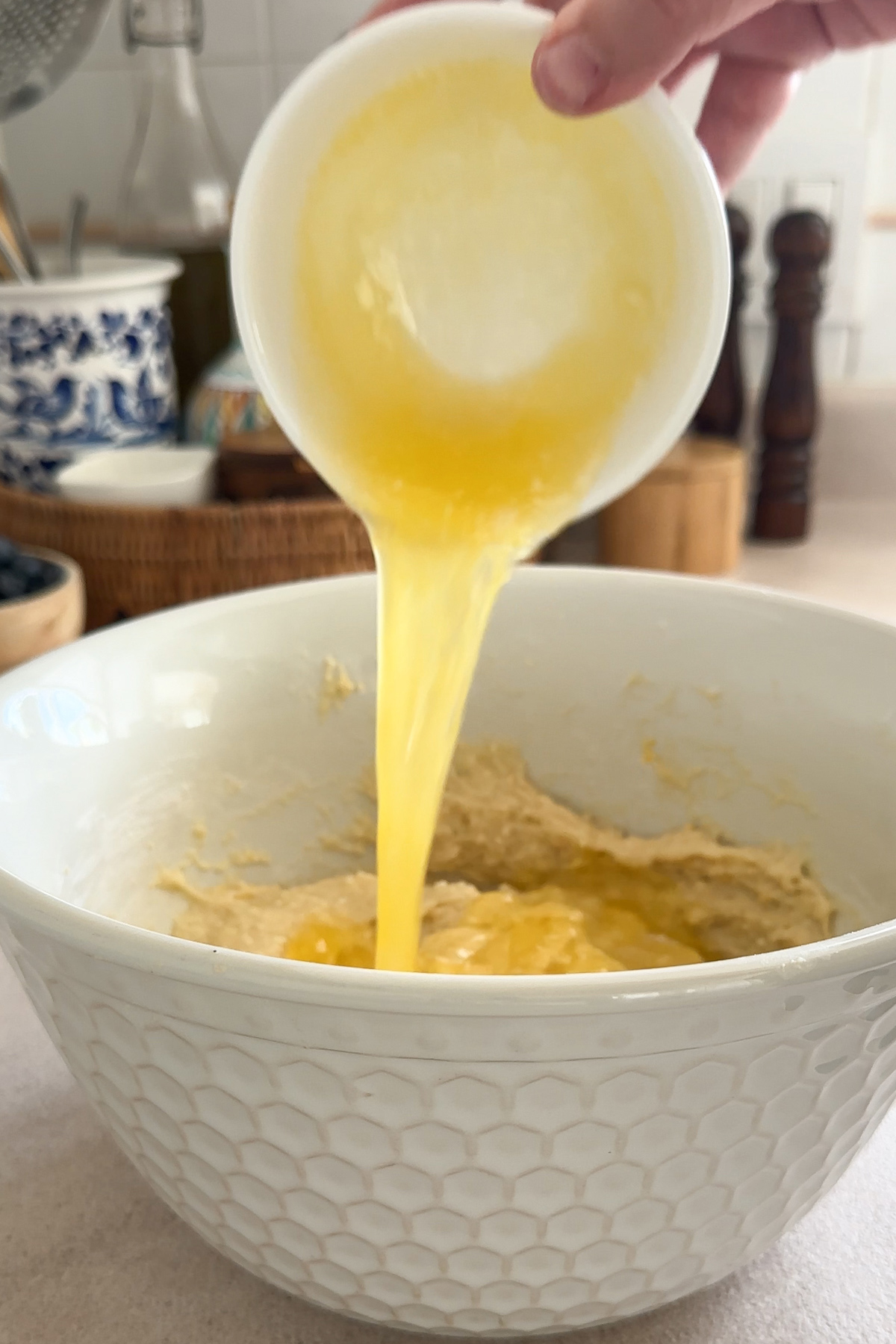 melted butter being poured into the cake batter