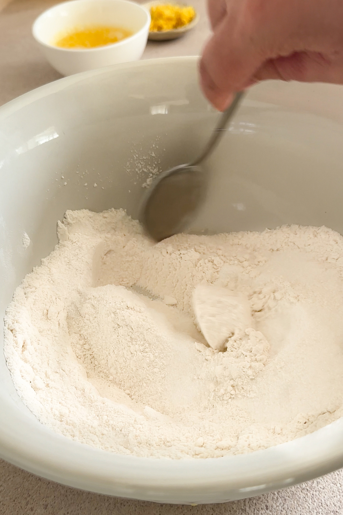 dry ingredients in a bowl being mixed with a spoon