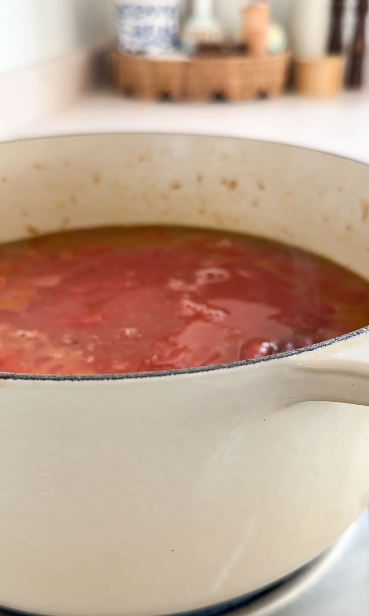 Passata poured on top of meat and soffritto in a pot