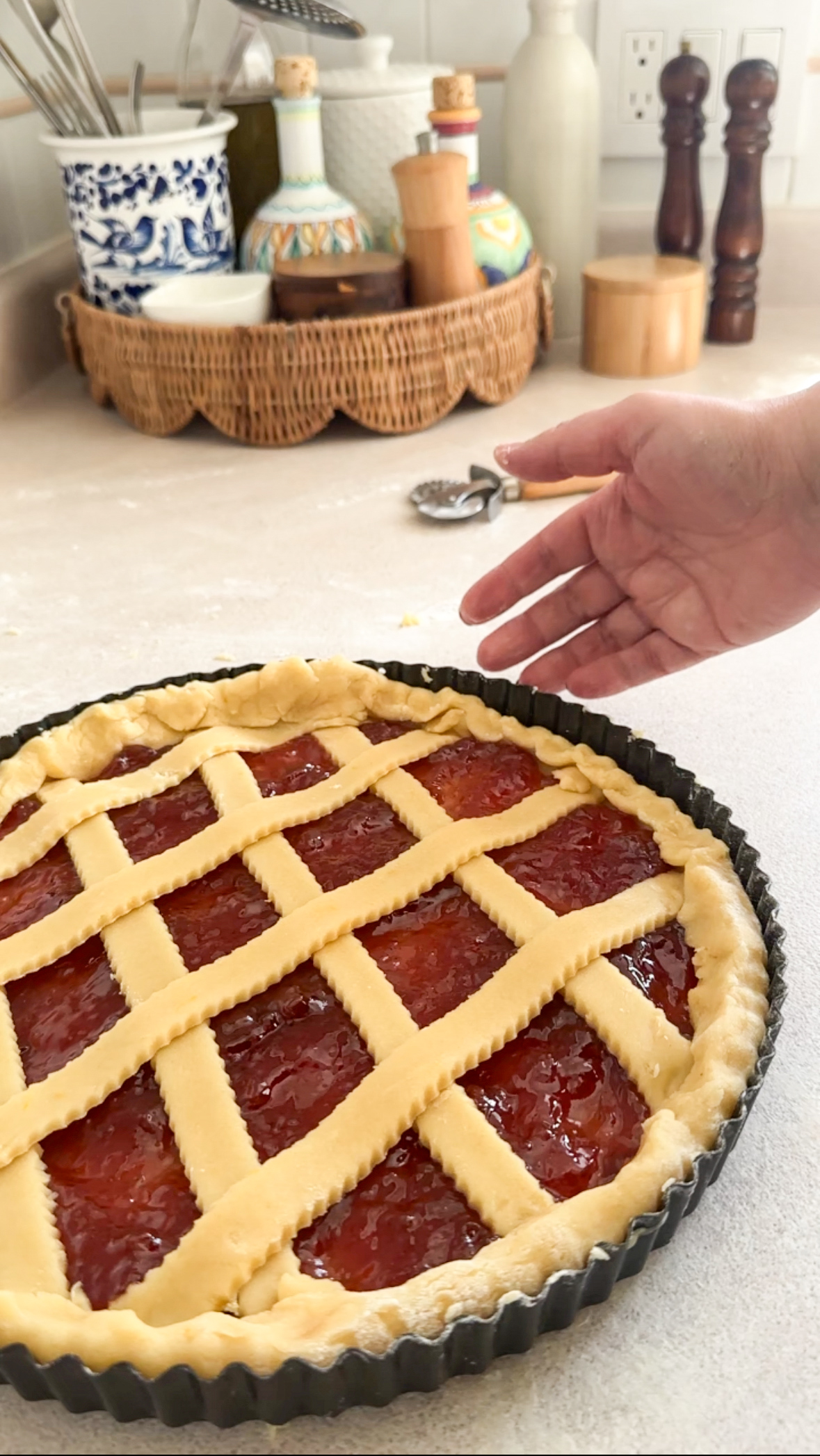 Unbaked crostata in tart pan topped with lattice design