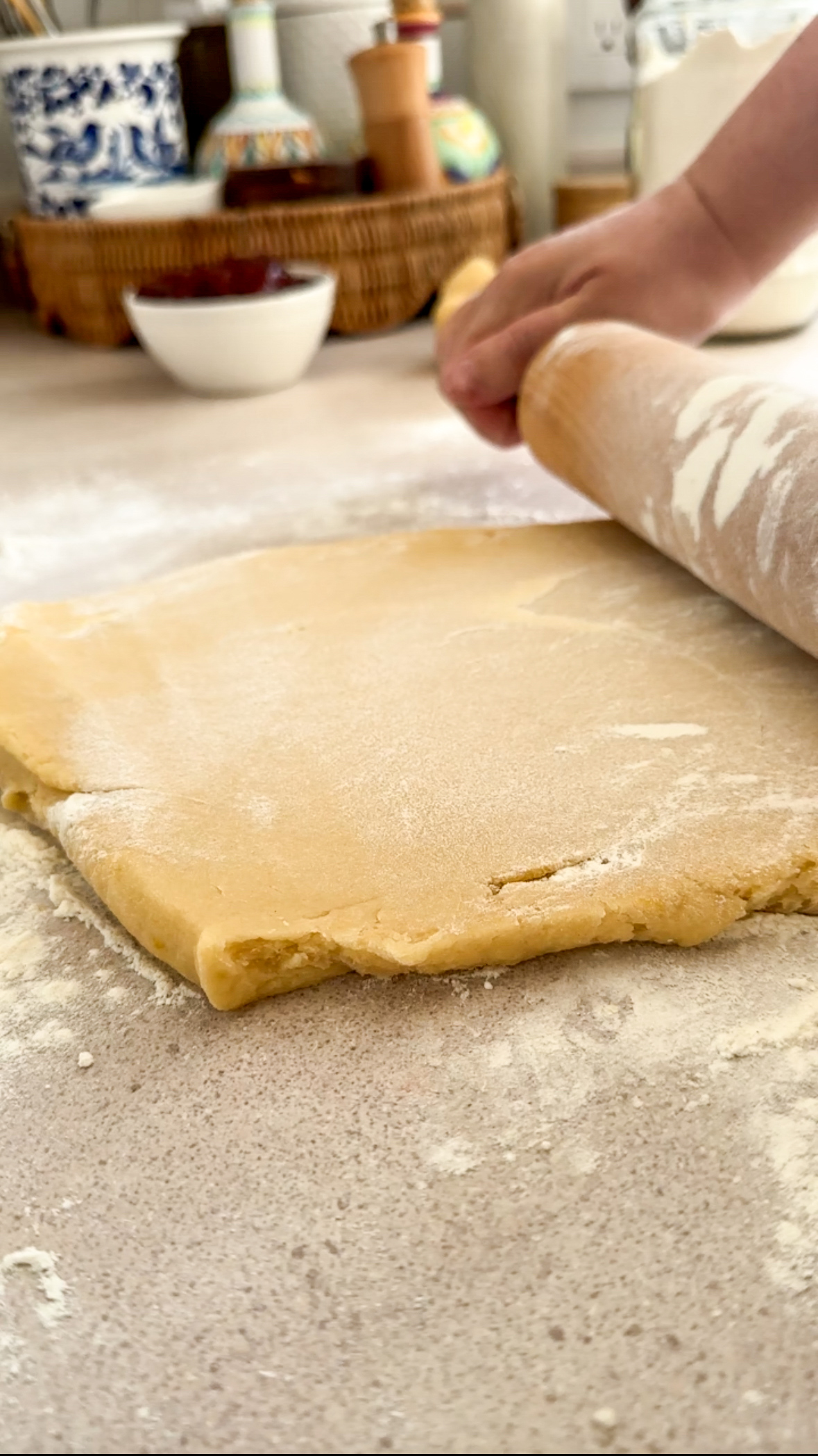 Crostata dough being rolled out with rolling pin