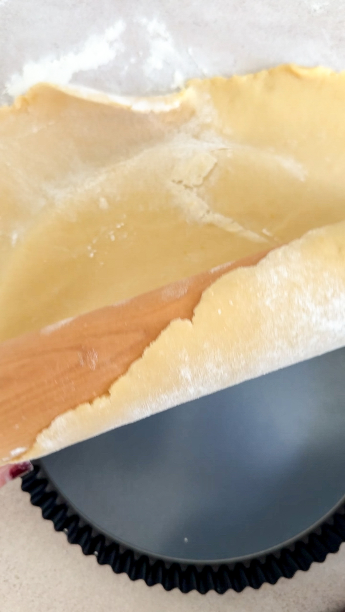 Crostata dough being put into tart pan