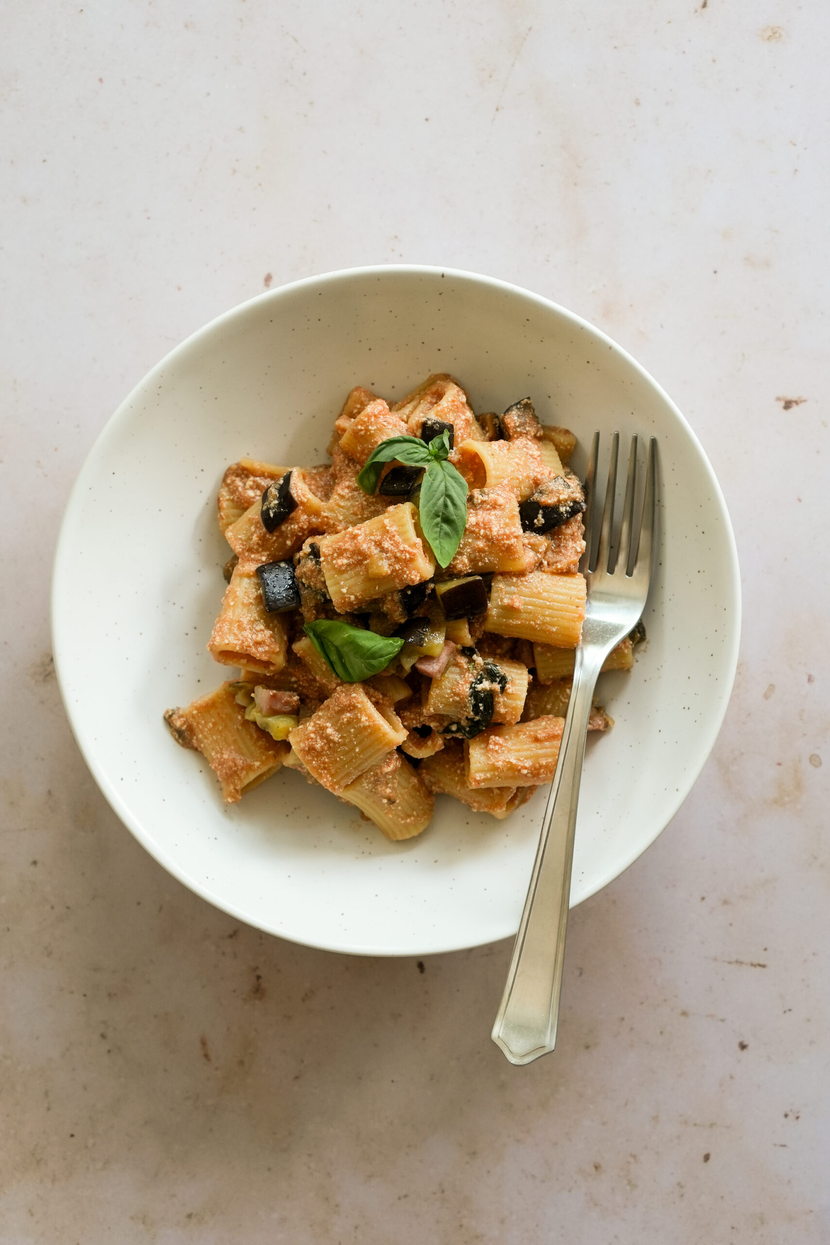 eggplant and ricotta pasta in a dish with a fork in it