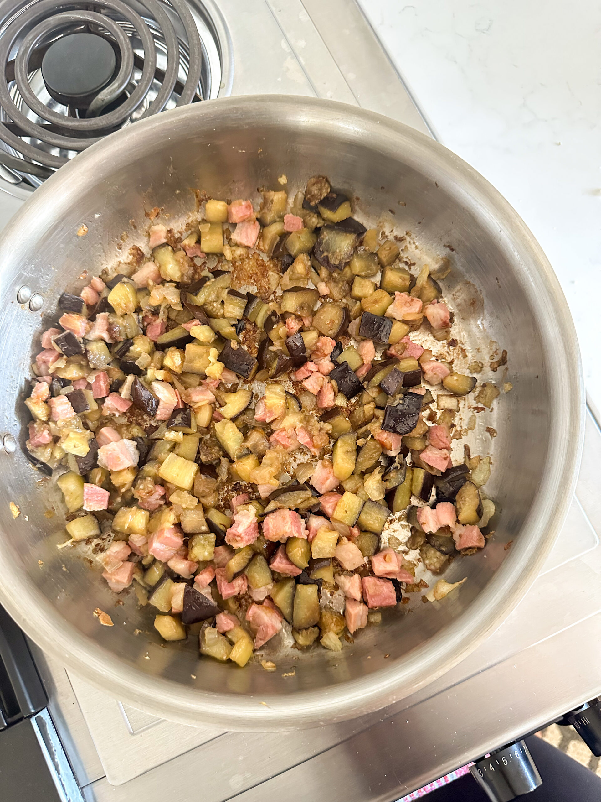 sauteed eggplant and pancetta in a pan