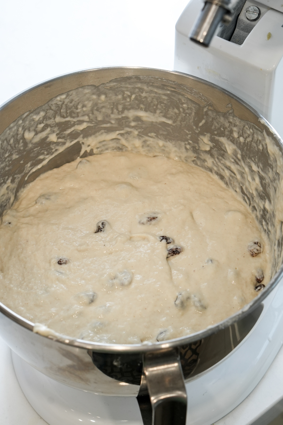 zeppole dough in a stand mixer bowl with raisins